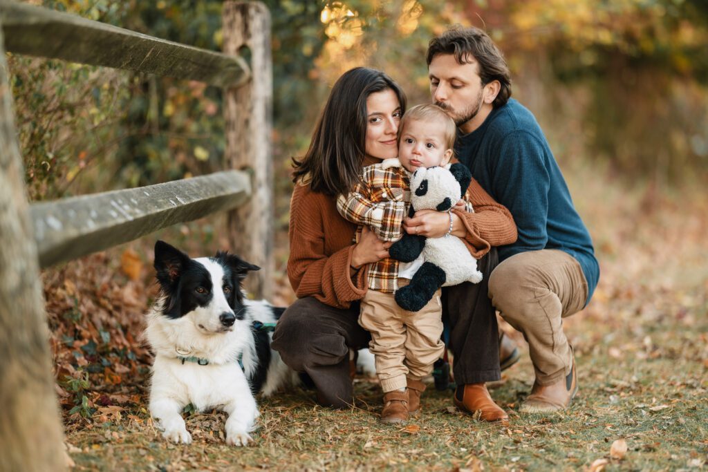 Fall family photo of parents with toddler boy and dog