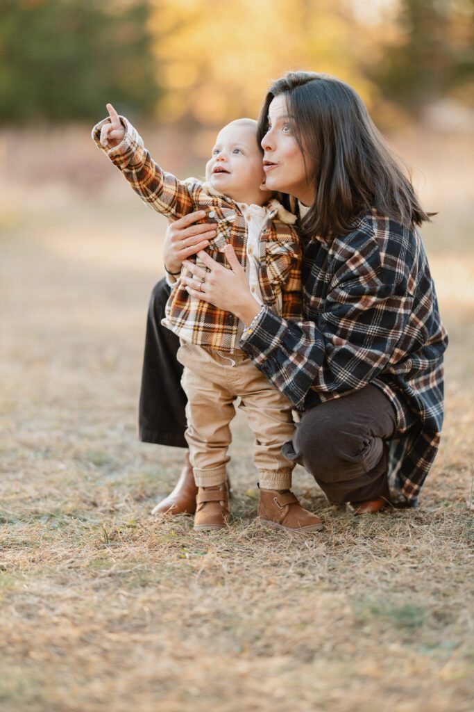 Fall family photo of mother and son in field wearing plaid