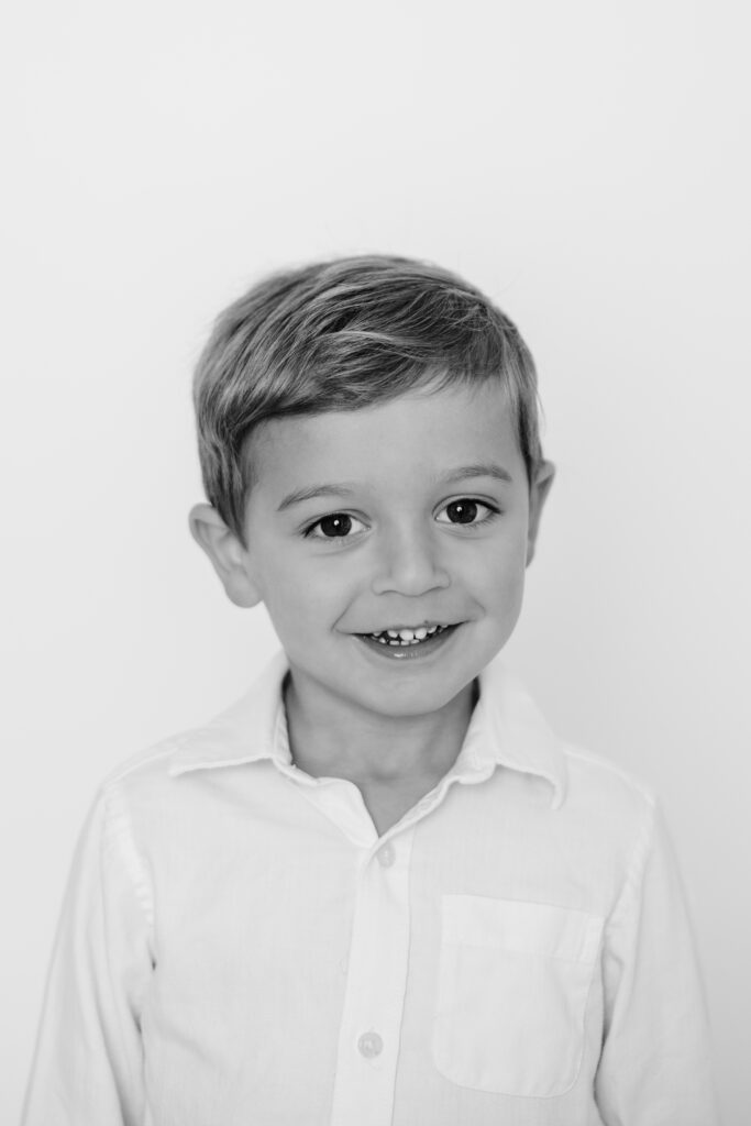 black and white personality portrait of toddler boy smiling