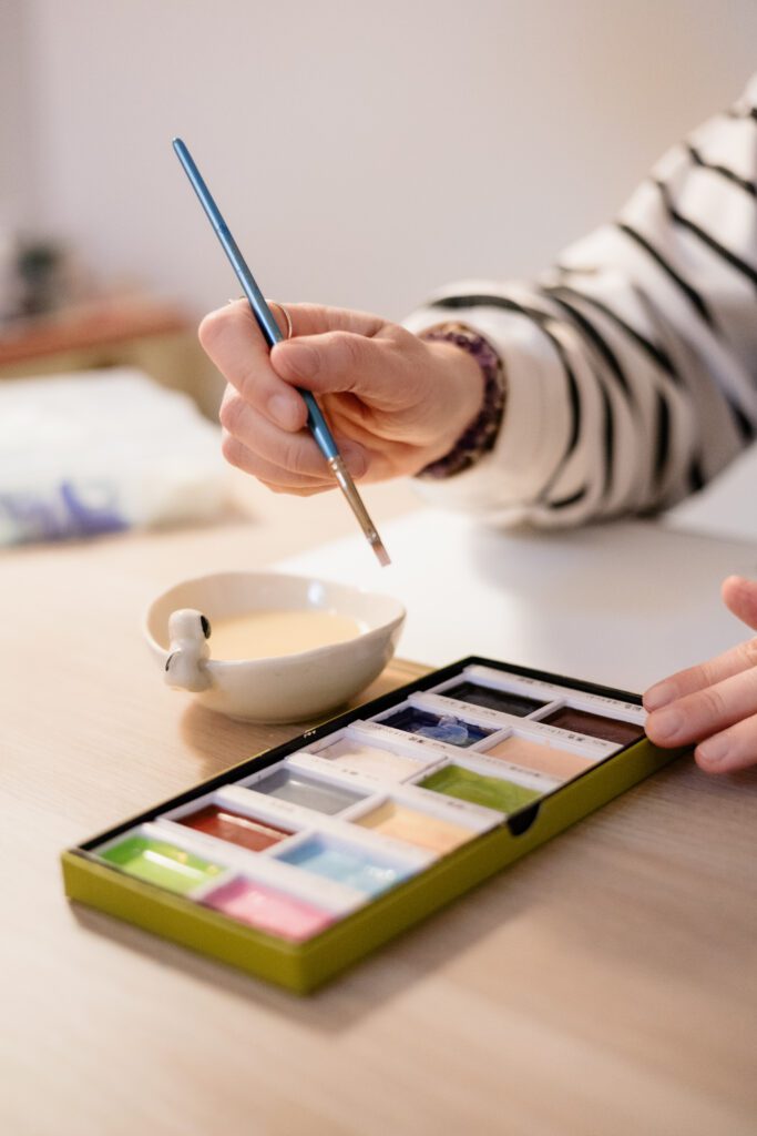 Personal brand photo of artist holding paintbrush
